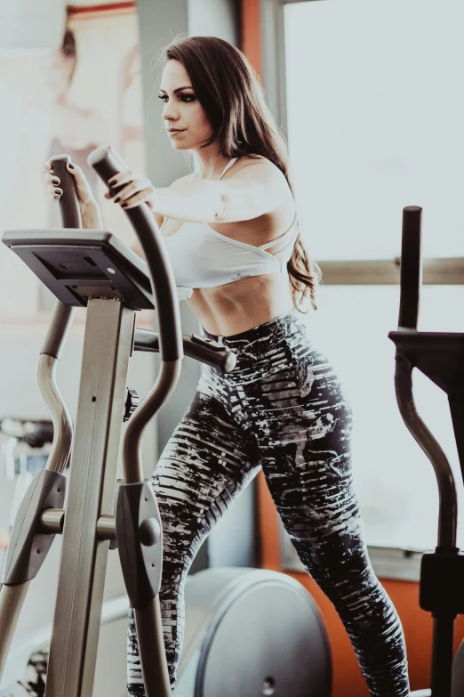 a woman on a stationary bike in a gym, by Robbie Trevino, pexels contest winner, shapely toned derriere, avatar image, walking, decorative