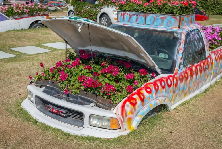 a truck with flowers growing out of the hood, inspired by Ed Roth, unsplash, on a hot australian day, coachella, upcycled, paul barson