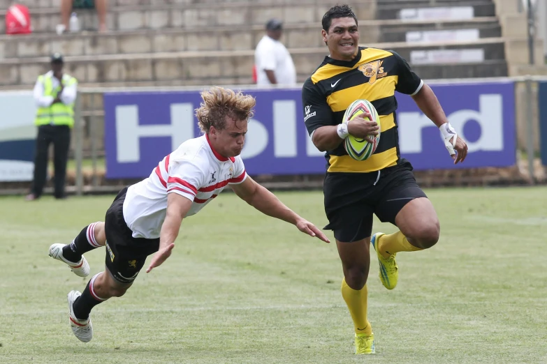 a couple of men playing a game of soccer, black and yellow and red scheme, sprinting, samoan features, joseph moncada