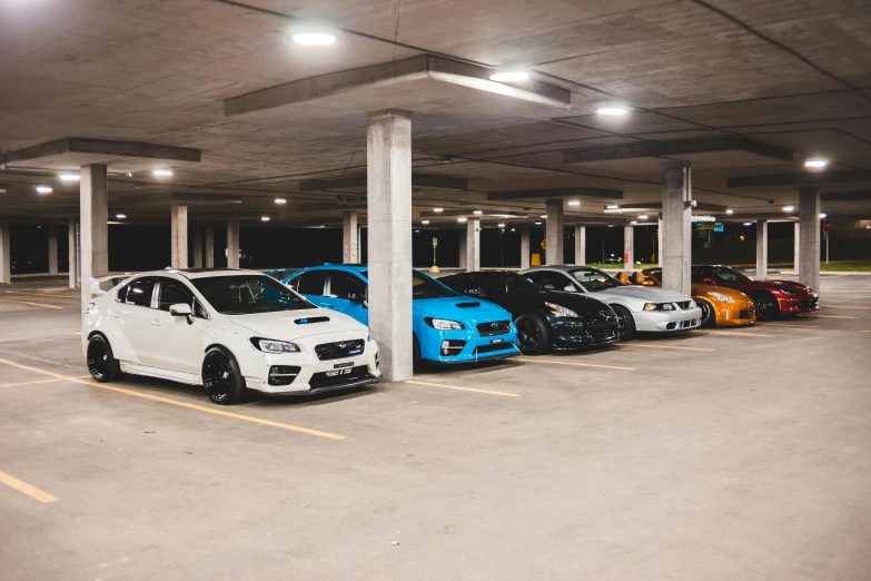 a row of cars parked in a parking garage, inspired by An Gyeon, unsplash, avatar image, australia, wrx golf, group photo