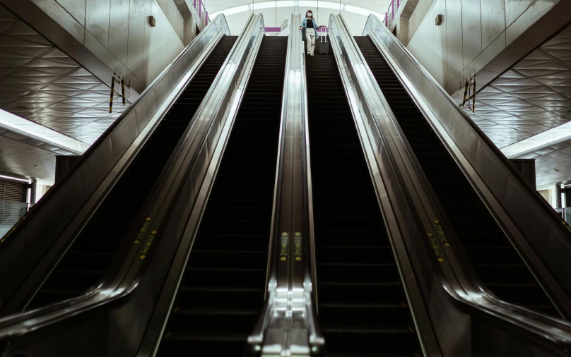 a couple of escalators that are next to each other, an album cover, unsplash contest winner, hyperrealism, purple tubes, hunting, gopro photo, female ascending