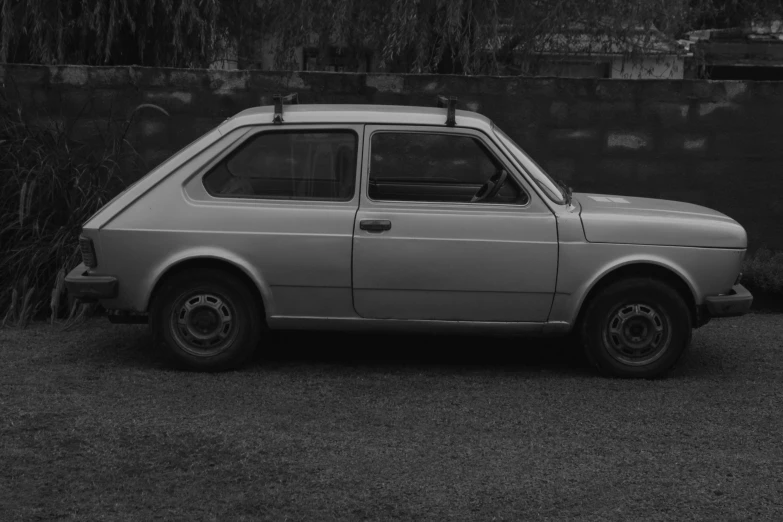 a black and white photo of a small car, unsplash, auto-destructive art, 1984, grisaille, romanian, sri lanka
