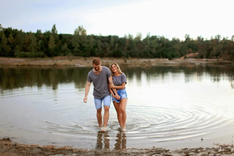 a man and a woman standing in a body of water, lachlan bailey, wet feet in water, profile image, mini lake