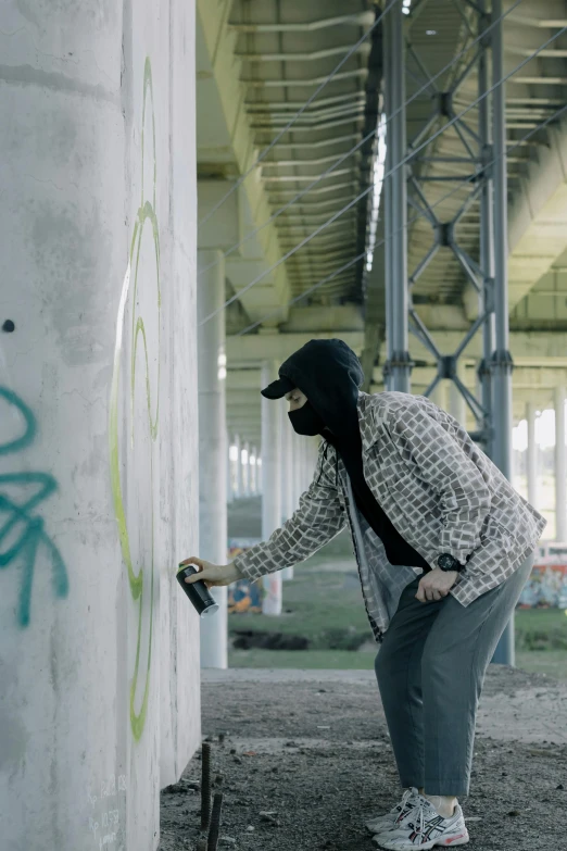 a person painting on a wall with a spray can, crimes, filmstill, thief, still from a live action movie