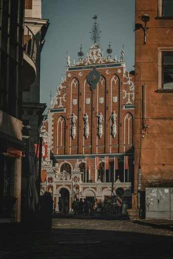 a tall building with a clock on top of it, by Adam Marczyński, pexels contest winner, baroque, brick building, a bustling magical town, pointed arches, payne's grey and venetian red