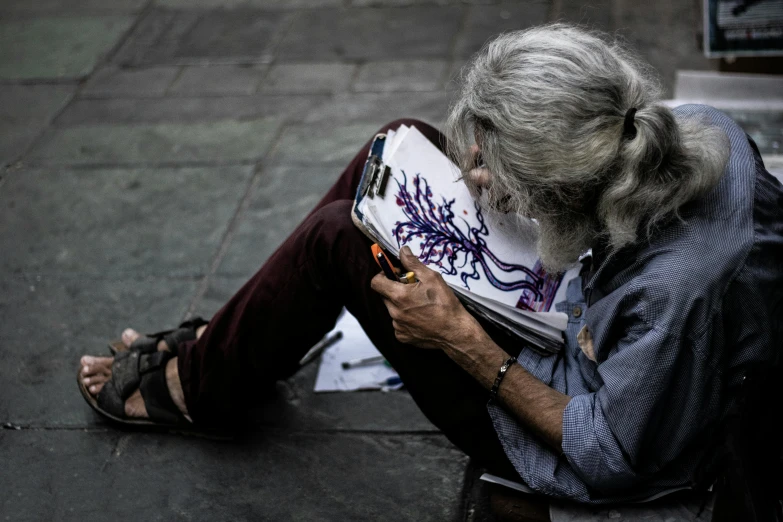 a person sitting on the ground reading a book, a drawing, pexels contest winner, street art, an oldman, long grey hair, colored photo, scribbled
