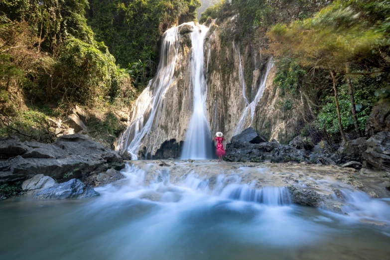 a person standing in front of a waterfall, by Julian Allen, sumatraism, myanmar, ultrawide image, slide show, thumbnail