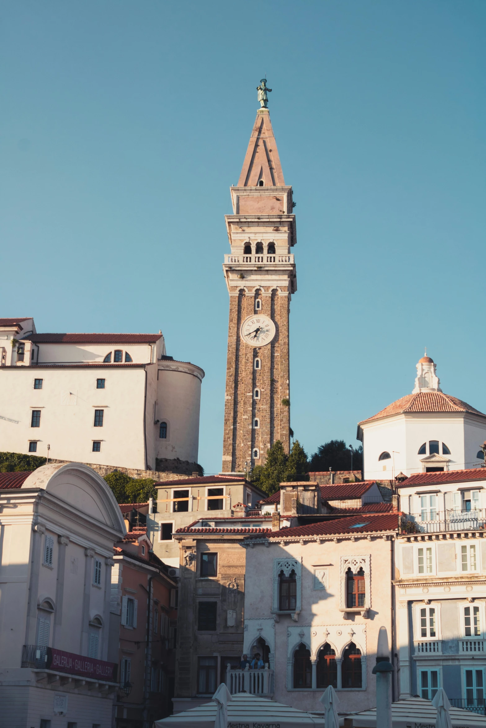 a tall clock tower towering over a city, renaissance, abbondio stazio, slightly sunny, zoomed out, port