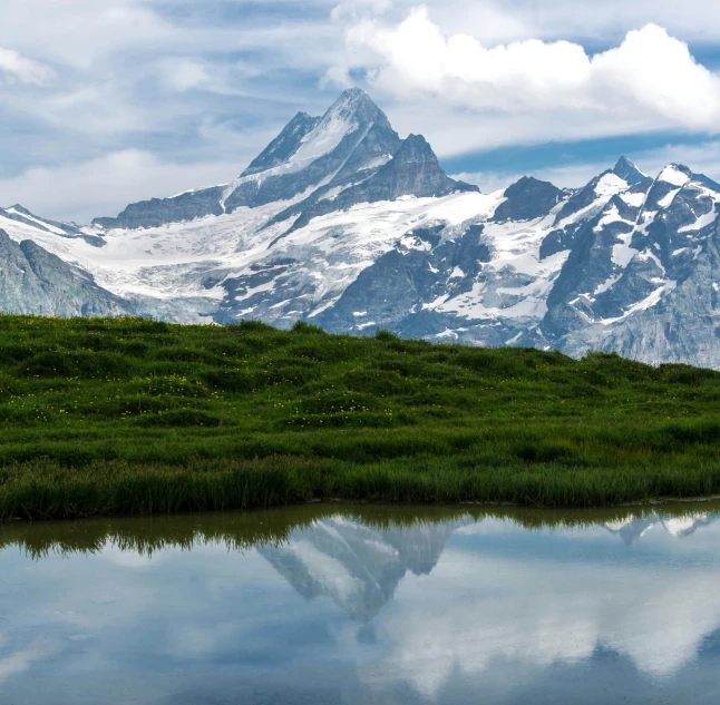 a body of water with a mountain in the background, by Werner Andermatt, pexels contest winner, hurufiyya, switzerland, lush scenery, conde nast traveler photo, peak experience ”