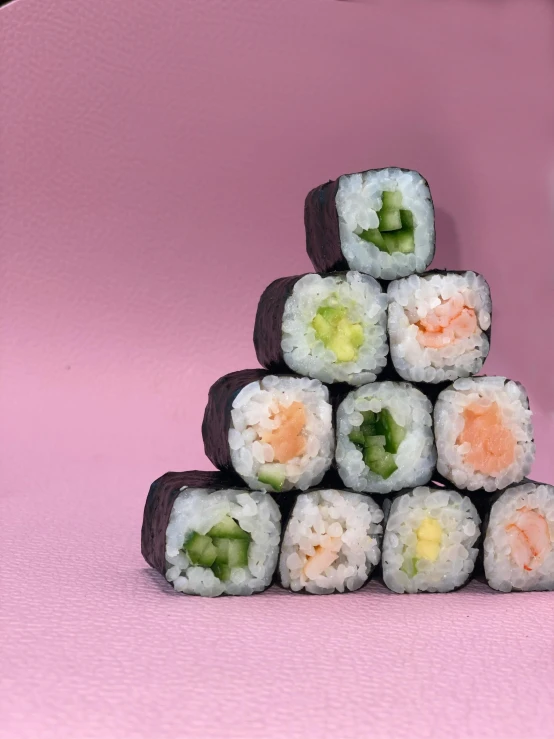 a stack of sushi rolls on a pink background, inspired by Maki Haku, unsplash, mingei, unedited, group photo, on a pale background, happy colours