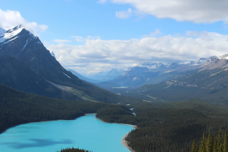 a large body of water sitting in the middle of a forest, by Hermione Hammond, pexels contest winner, banff national park, blue glacier, looking down at the valley, slide show