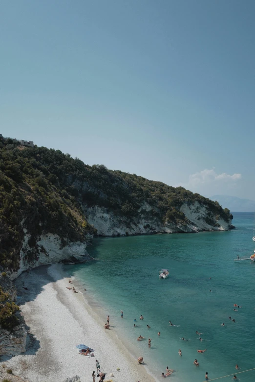 a group of people on a beach next to a body of water, greek nose, white sandy beach, cinematic shot!, lush surroundings