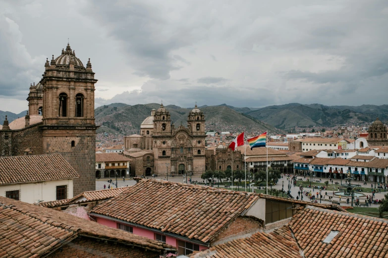 a view of a city from the top of a building, a photo, by Julia Pishtar, pexels contest winner, quito school, square, grey skies with two rainbows, pink marble building, quechua