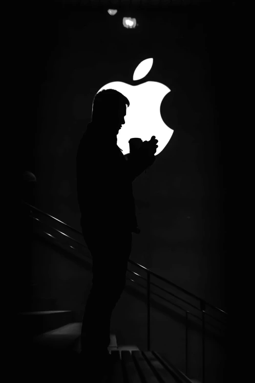 a man standing in front of an apple logo, a black and white photo, back lit, photo taken in 2 0 2 0, profile pic, instagram post