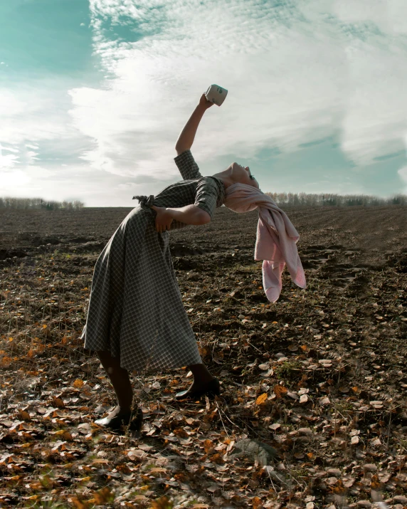 a woman doing a handstand in a field, an album cover, by Lucia Peka, pexels contest winner, surrealism, zombie holding coffee cup, ukraine, performance art, 15081959 21121991 01012000 4k