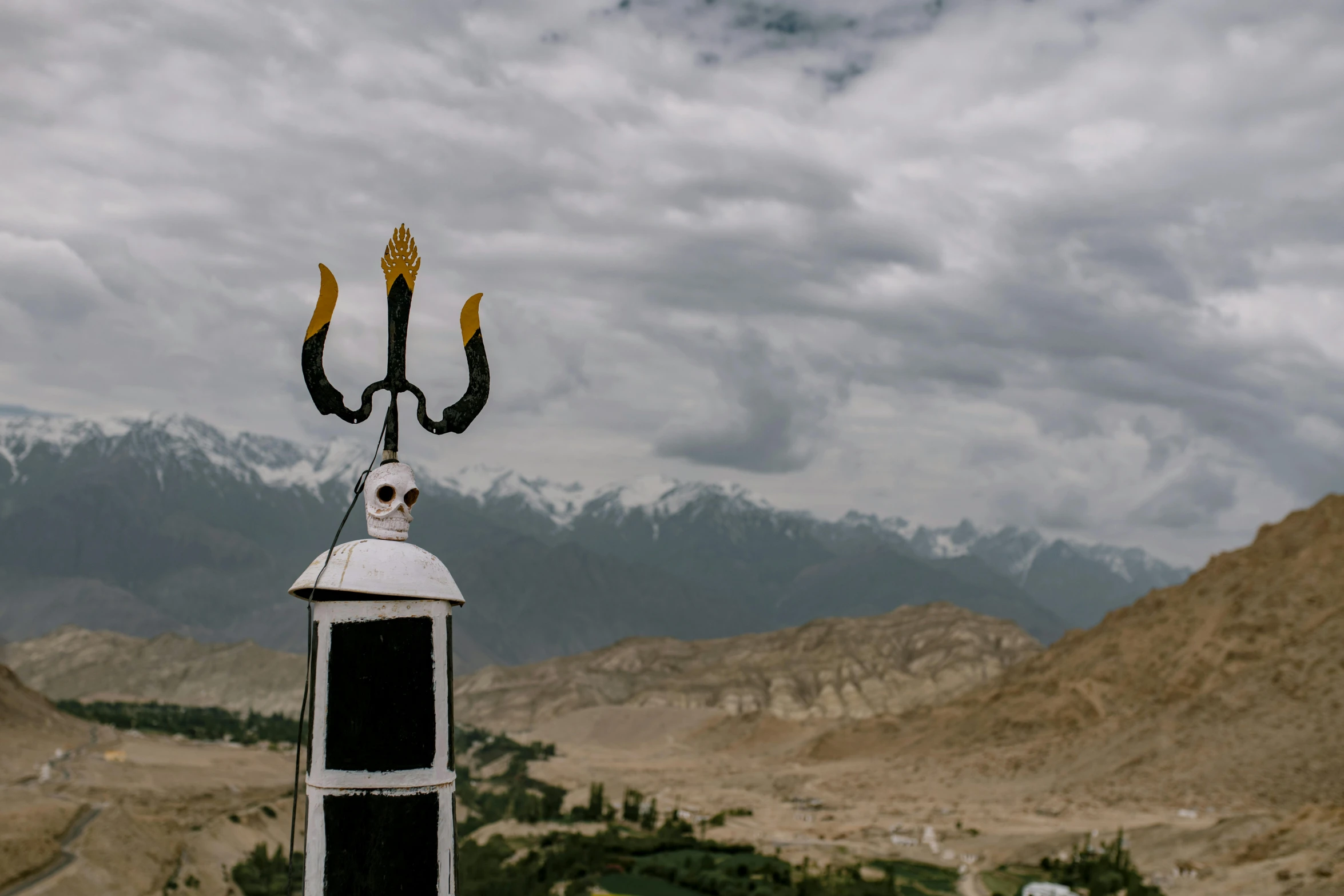 a weather vane with mountains in the background, a statue, by Julia Pishtar, pexels contest winner, indian temple, background image, ominous and intense, minarets