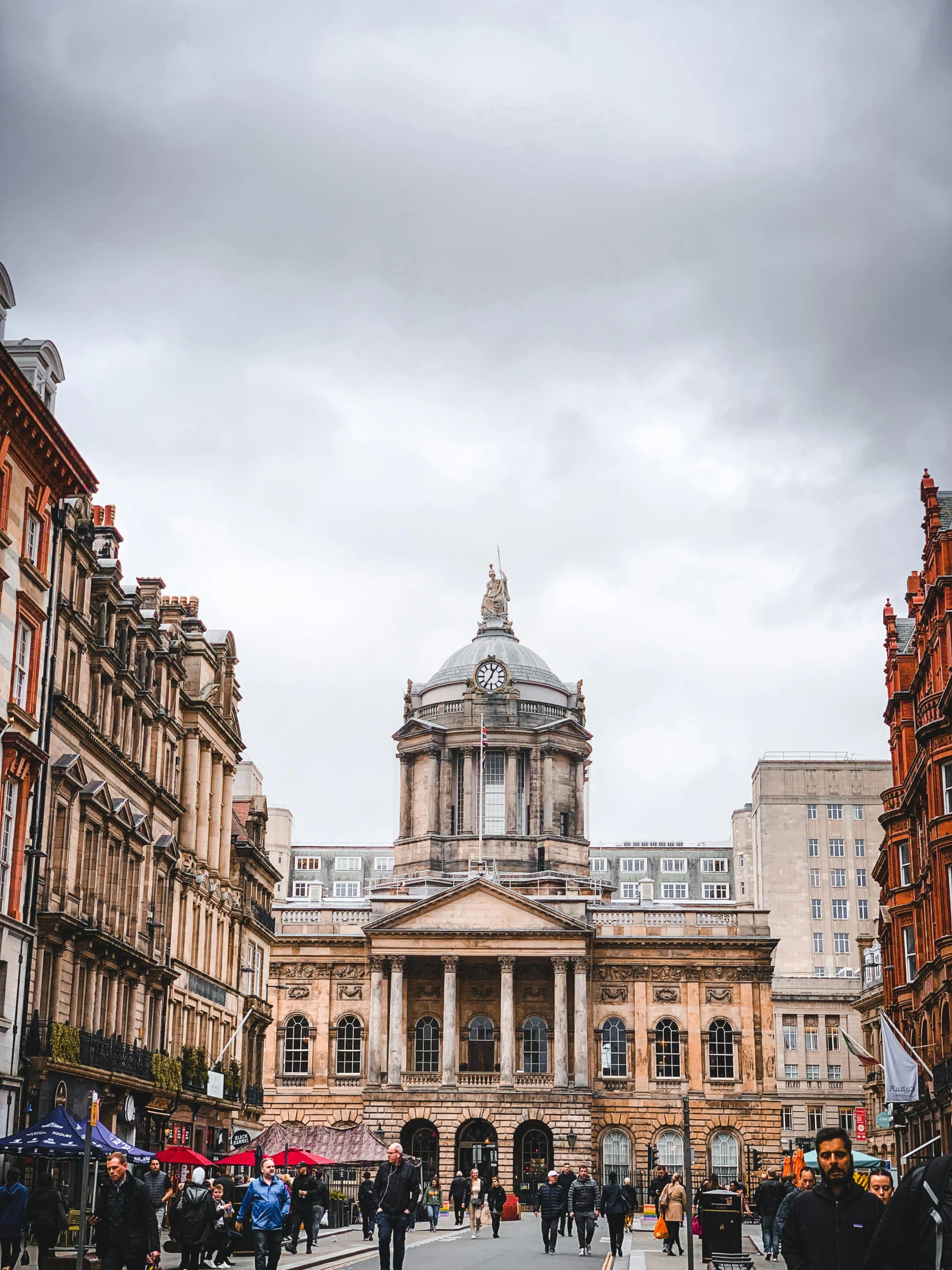 a group of people walking down a street next to tall buildings, by IAN SPRIGGS, unsplash contest winner, renaissance, hull is a opera house, on a great neoclassical square, profile image, house bolton