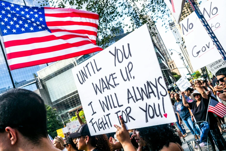 a man holding a sign that says until you wake up i will always fight for you, a photo, by Julia Pishtar, flag, attacking nyc, thumbnail, usa-sep 20