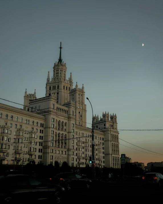 a large white building with a clock tower, unsplash contest winner, socialist realism, gta in moscow, lgbtq, humid evening, the moon on the top right