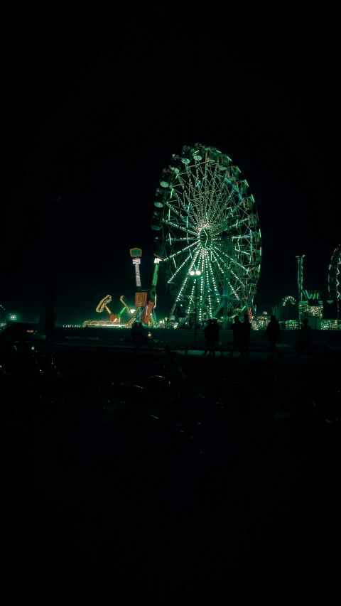 a ferris wheel is lit up at night, pexels contest winner, shot on expired instamatic film, a green, coachella, boardwalk