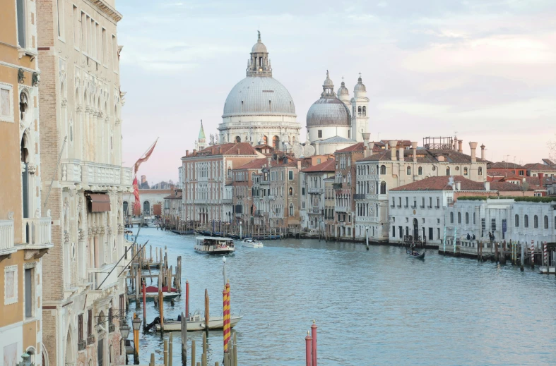 a river running through a city next to tall buildings, an album cover, by Canaletto, pexels contest winner, renaissance, white buildings with red roofs, venice biennale, with great domes and arches, pink marble building