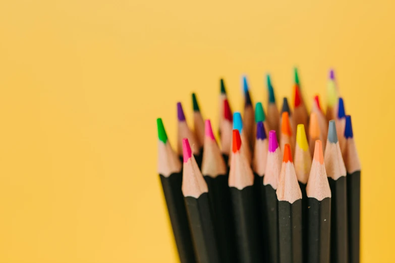 a cup filled with lots of colored pencils, a child's drawing, trending on pexels, yellow and black color scheme, 🎨🖌️, bottom - view, subtle detailing