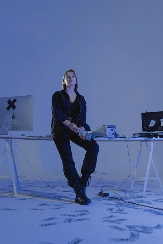 a woman sitting at a desk in front of a computer, inspired by Marina Abramović, video art, 2 techwear women, standing sideways, instrument, blue