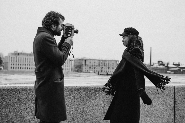 a man taking a picture of a woman with a camera, a black and white photo, oona chaplin, russian, medium format, movie filmstill