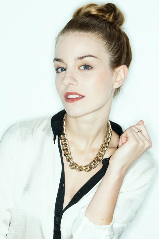 a woman in a white shirt posing for a picture, wearing gold chain, sydney sweeney, gilt metal, wearing collar