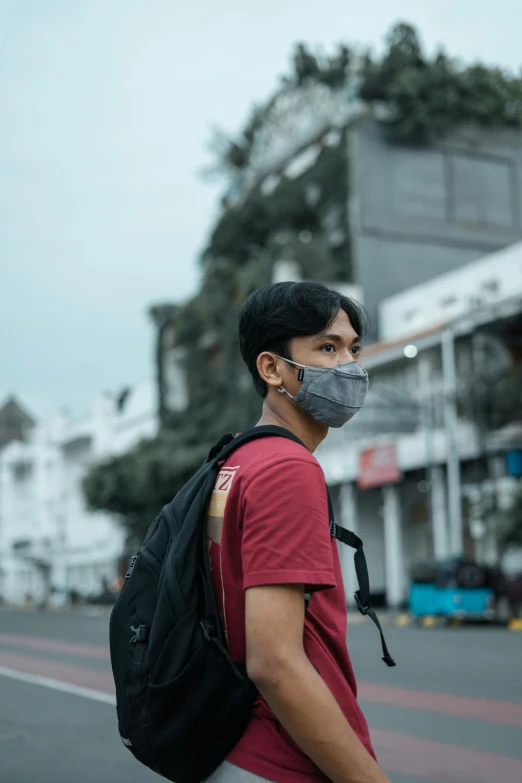 a man wearing a face mask on a street, pexels contest winner, jakarta, maroon and white, avatar image, a man wearing a backpack