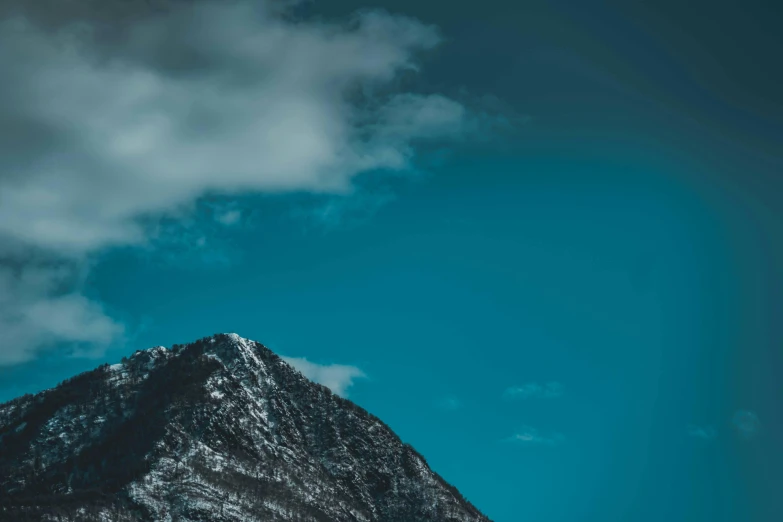a snow covered mountain under a blue sky, pexels contest winner, minimalism, on a dark background, turquoise, one contrasting small feature, portrait photo