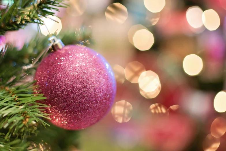 a pink ornament hanging from a christmas tree, pexels, happening, pearlescent, thumbnail, opening shot, evergreen