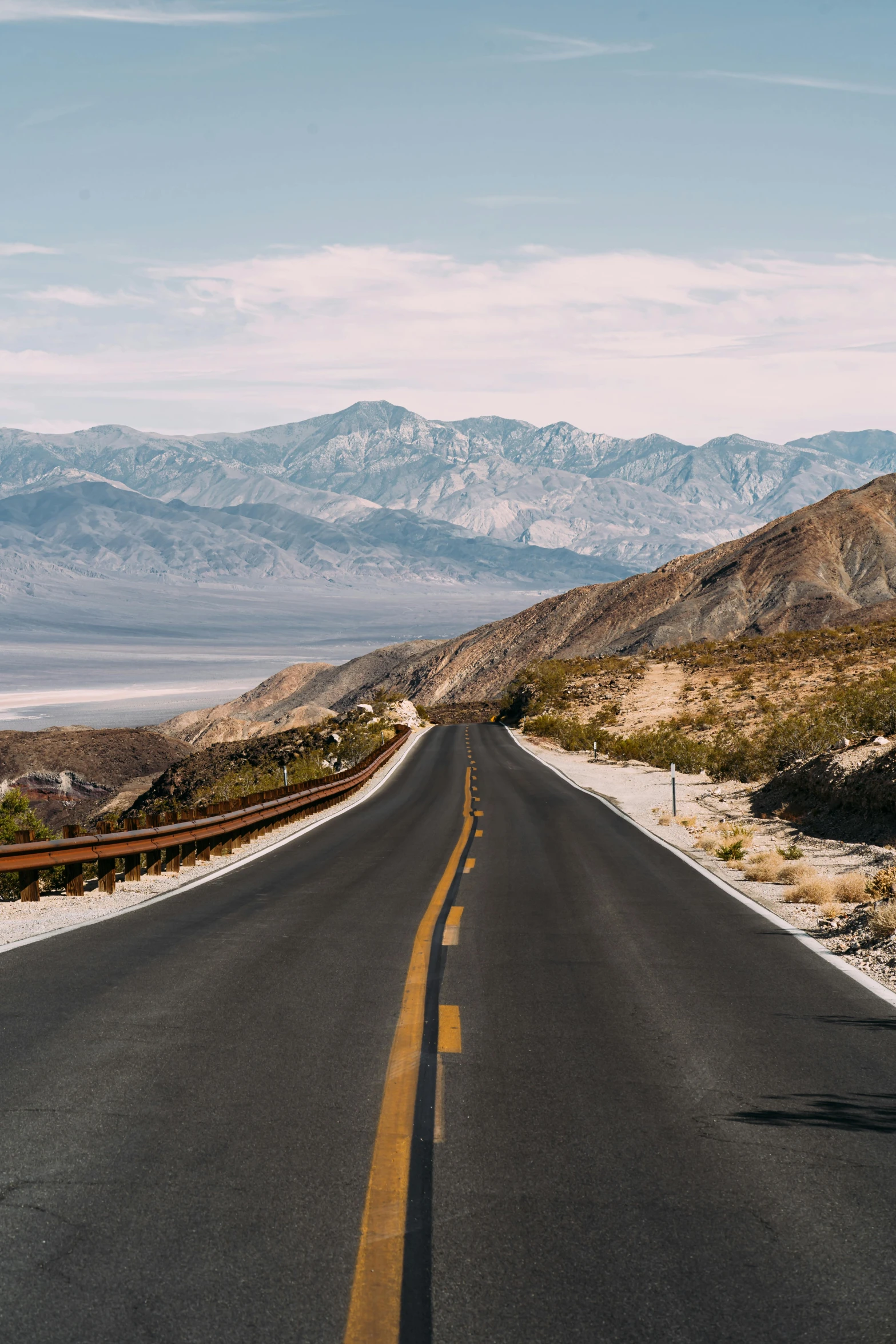 an empty road in the desert with mountains in the background, by Whitney Sherman, unsplash contest winner, chemistry, downhill landscape, slate, promo image