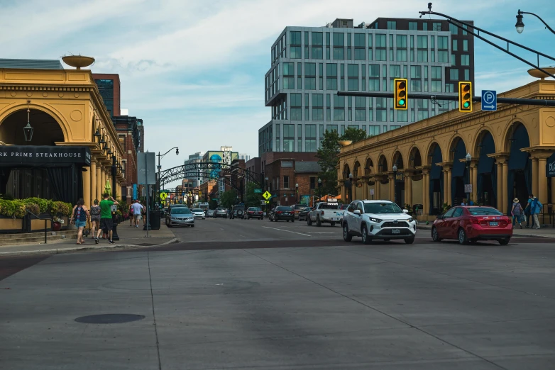 a street filled with lots of traffic next to tall buildings, a photo, winnipeg skyline, old town, fan favorite, preserved historical