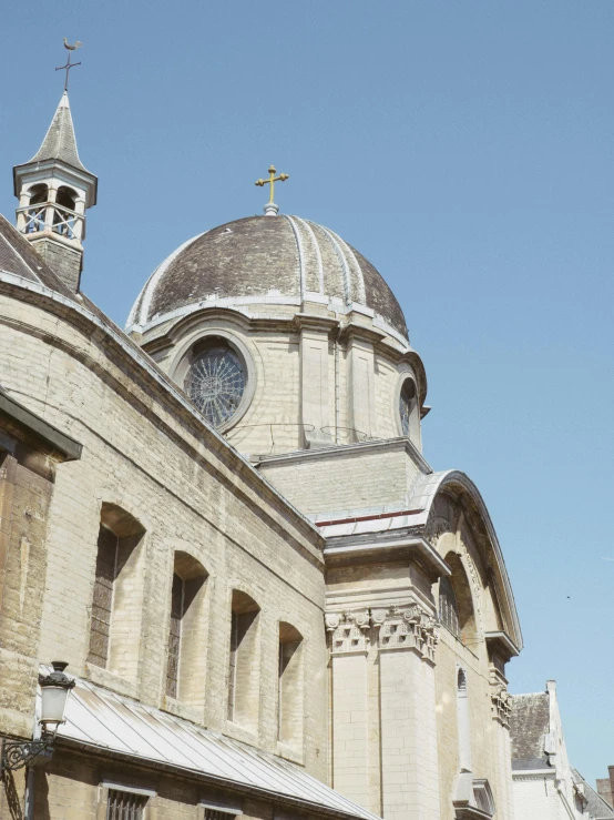 a large building with a clock on top of it, inspired by Christopher Wren, romanesque, rounded roof, a blond, profile image, holy cross