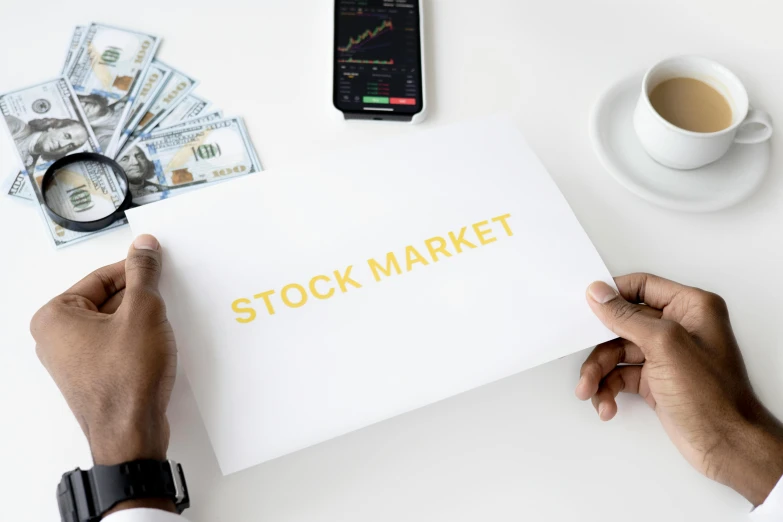 a man holding a piece of paper with the word stock market on it, a photo, trending on pexels, sots art, square, 1 0, b, brown
