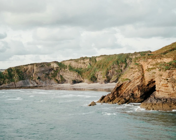 a large body of water next to a cliff, by Jessie Algie, pexels contest winner, les nabis, dean cornwall, conde nast traveler photo, seen from a distance, thumbnail