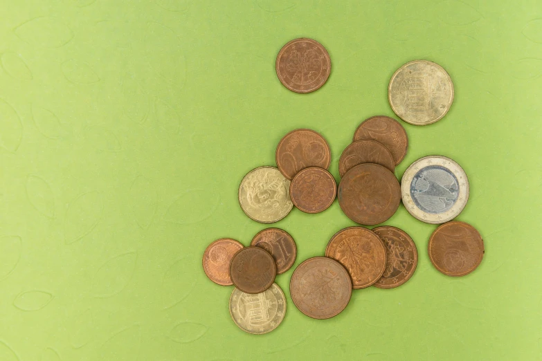 a pile of coins sitting on top of a green surface, various items, thumbnail, brown:-2, no watermarks