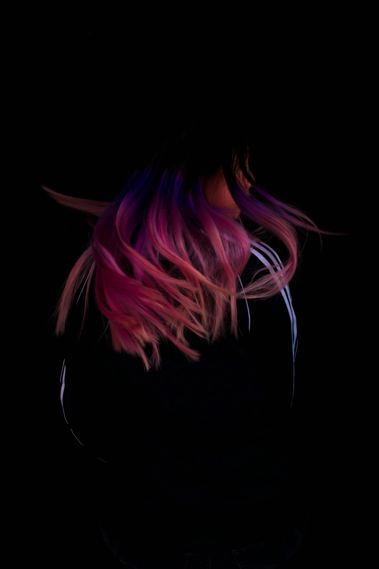 a woman with pink hair in the dark, an album cover, inspired by Elsa Bleda, trending on pexels, black to purple fade hairstyle, ( ( vibrating colors ) ), back of the hair, inverse color