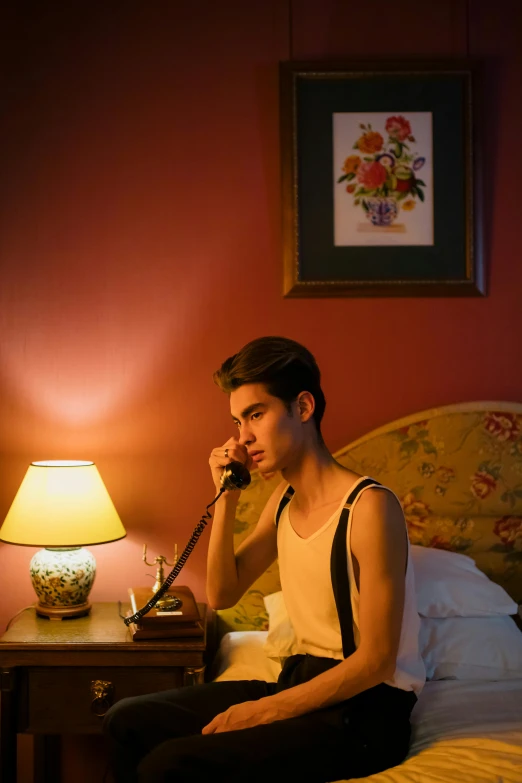 a man sitting on a bed talking on a phone, a portrait, inspired by Nan Goldin, trending on pexels, 1 9 2 0's style speakeasy, bisexual lighting, timothee chalamet, ( ( theatrical ) )