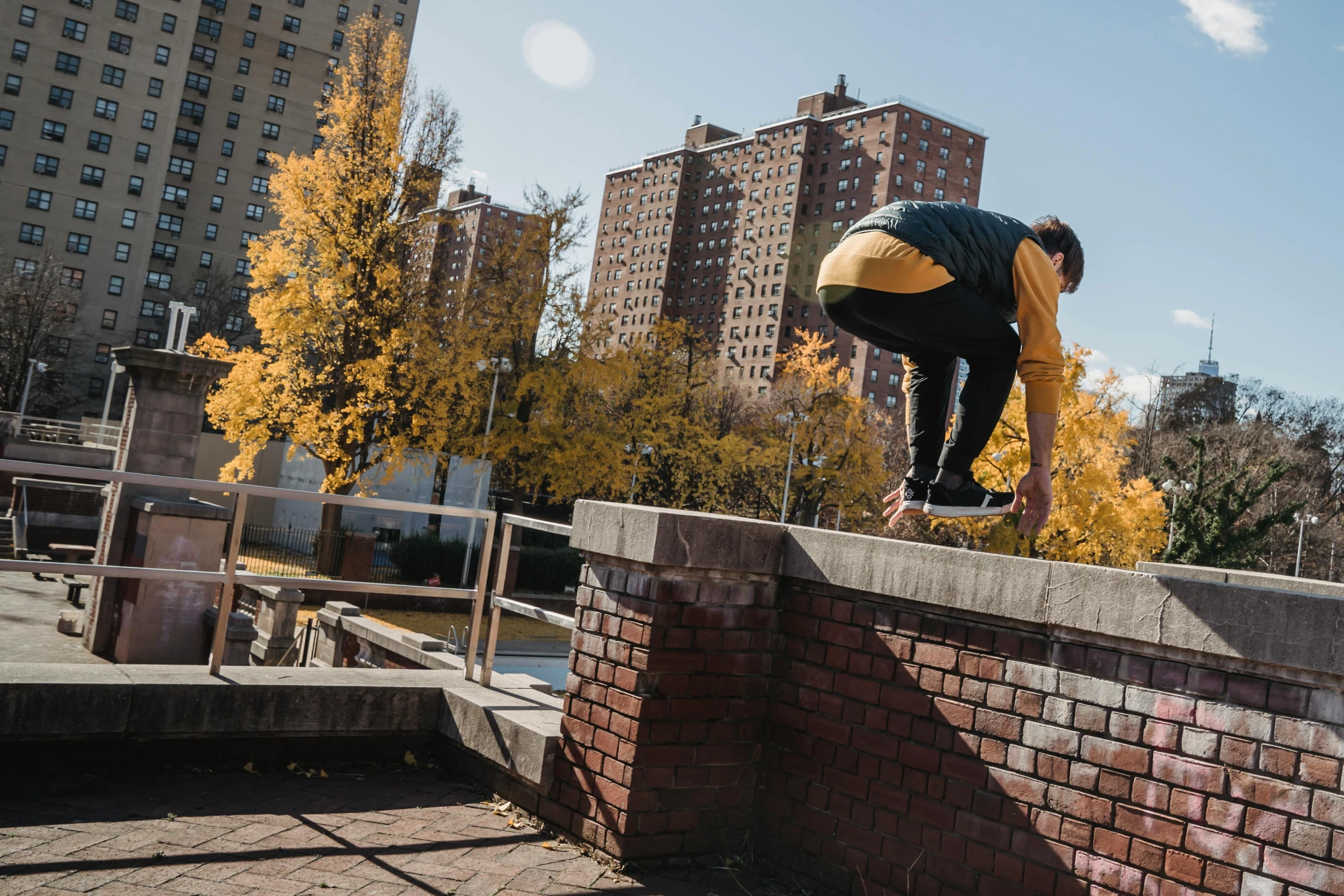 a man flying through the air while riding a skateboard, by William Berra, unsplash, lush brooklyn urban landscaping, mid fall, structure : kyle lambert, ignant