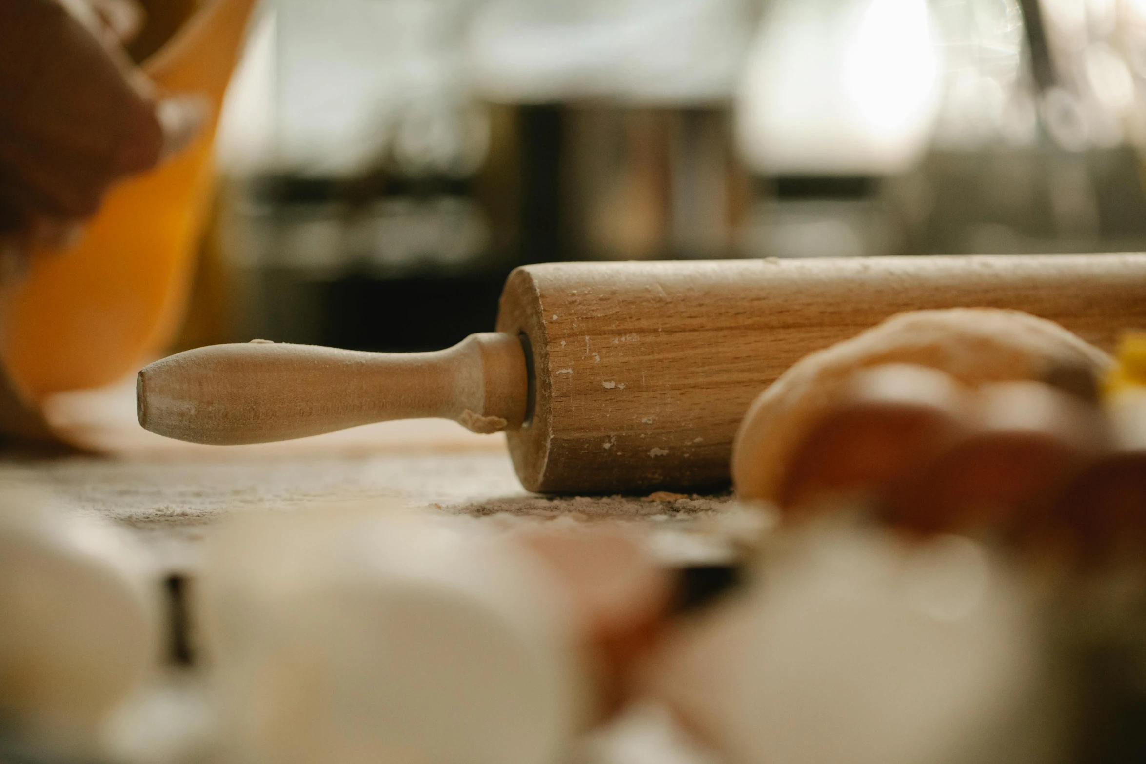 a person rolling out dough on a table, inspired by Sarah Lucas, trending on pexels, wooden staff, middle close up, thumbnail, cooking