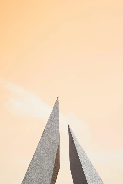 a couple of planes that are flying in the sky, an abstract sculpture, by Sven Erixson, trending on unsplash, postminimalism, pyramid head, grey orange, pointed arches, soviet architecture