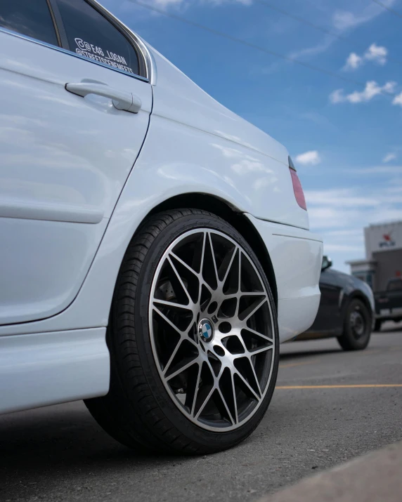 a white car parked on the side of the road, black rims, hyperdetailled, thumbnail, webs