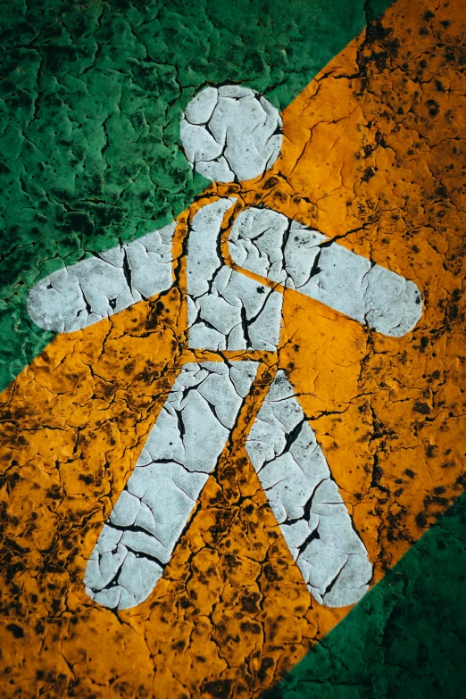 a close up of a sign with a person on it, an album cover, inspired by William Conor, unsplash, stone roads, orange and green power, human - shaped, crossing the line