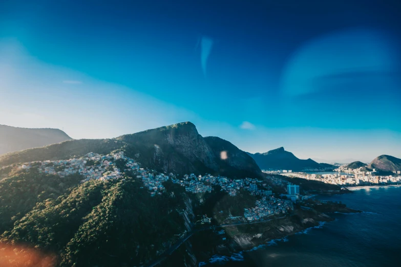 a view of a city from the top of a mountain, pexels contest winner, rio de janeiro, avatar image, view from helicopter, blue and clear sky