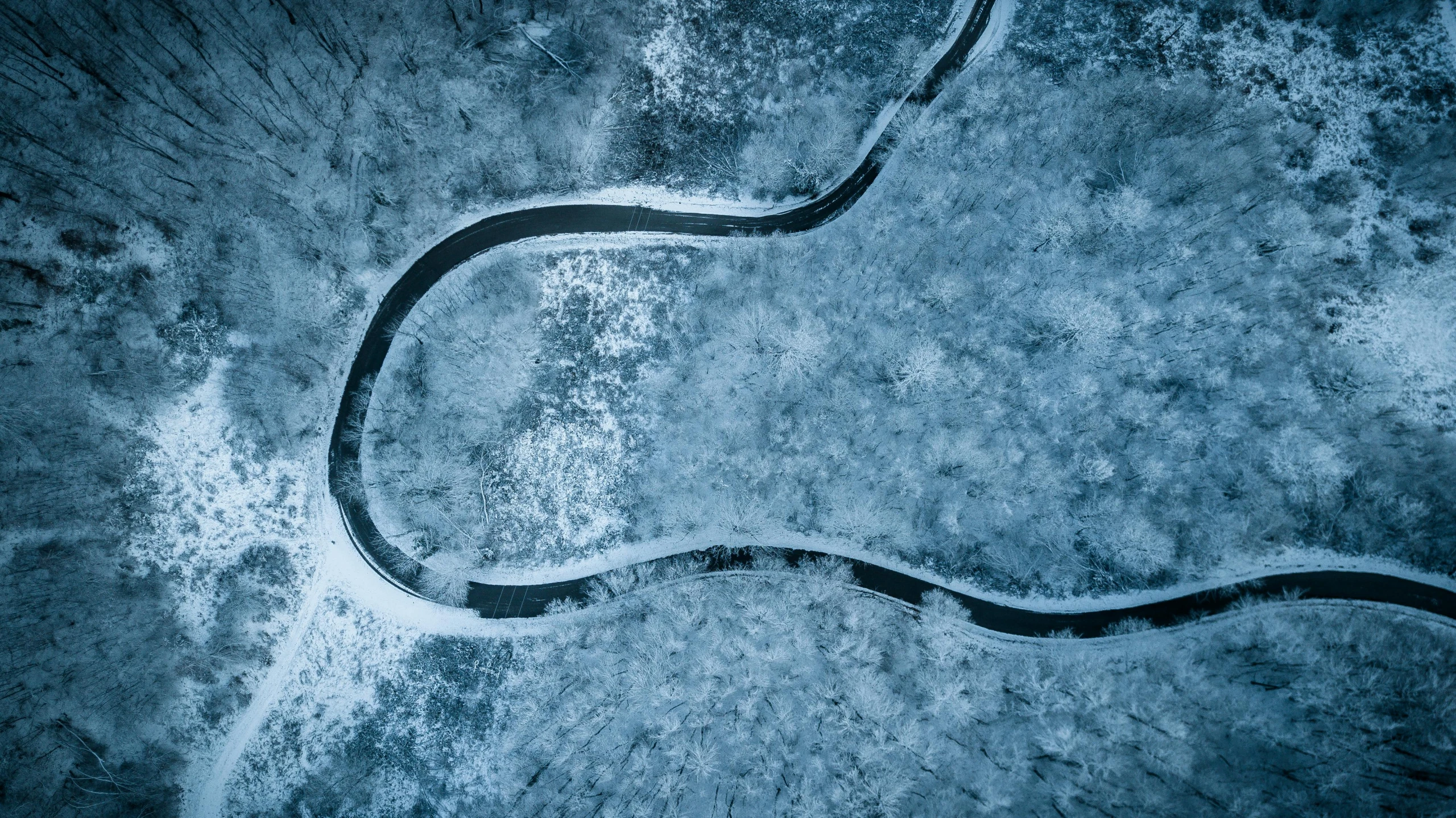 an aerial view of a winding road in the snow, an album cover, by Adam Marczyński, unsplash contest winner, land art, river of blue fire, thumbnail, blue, dragonfly-shaped