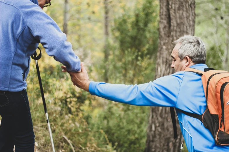 a man and a woman holding hands in the woods, unsplash, hiking cane, avatar image, two men hugging, older male