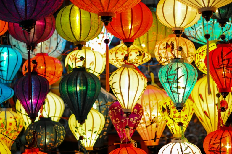 a bunch of colorful lanterns hanging from a ceiling, a silk screen, trending on pexels, lamp posts, vietnam, glowy light, we go