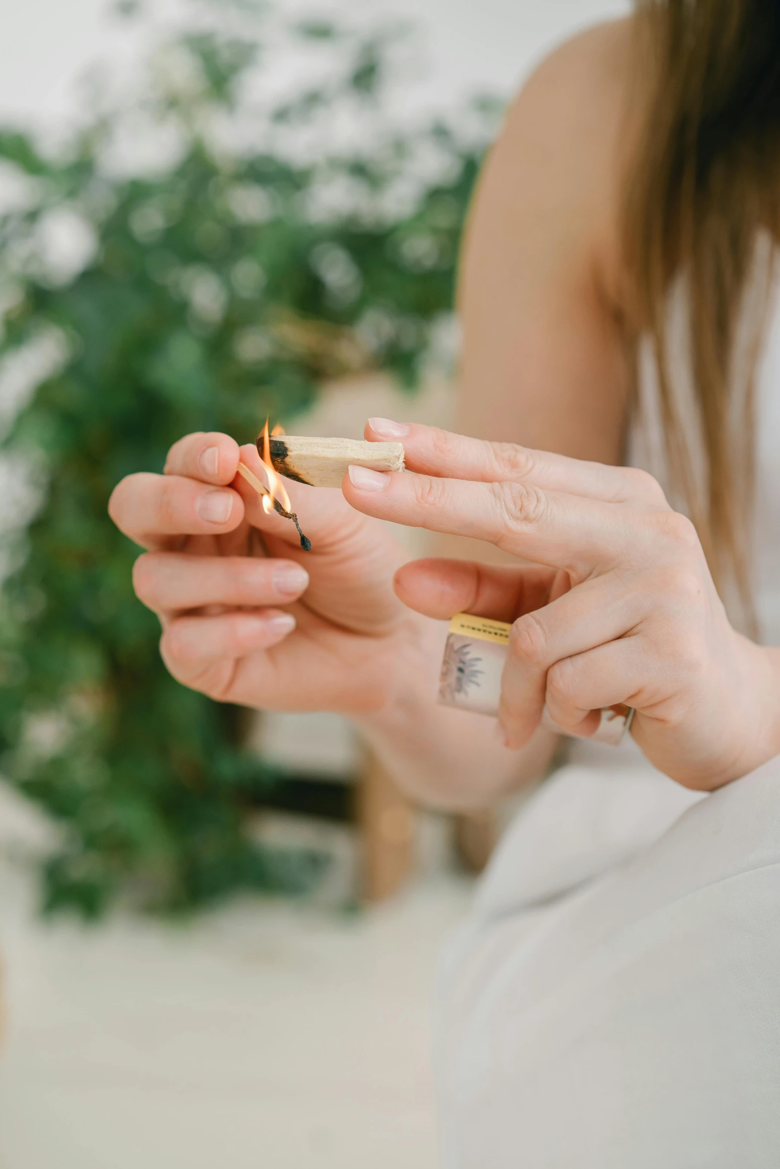 a close up of a person holding a ring, holding a cigarette, natural candle lighting, oils, white and gold